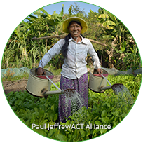 woman watering graden with two watering cans