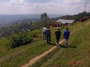 Companions and YAGM volunteers walk along the hillside in Gicumbi Photo credit: Janelle Neubauer